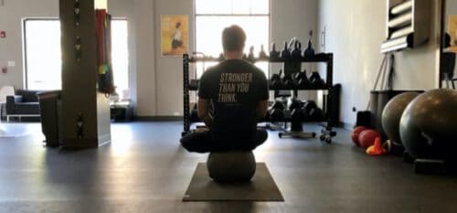 man balancing on exercise ball