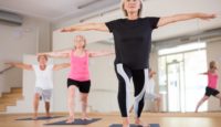 Mature,Women,Exercising,Yoga,Pose,During,Their,Group,Training.