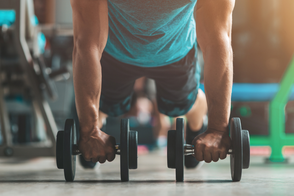 For,Your,Better,Shape.,Young,Man,In,Sportswear,Exercising,Indoors